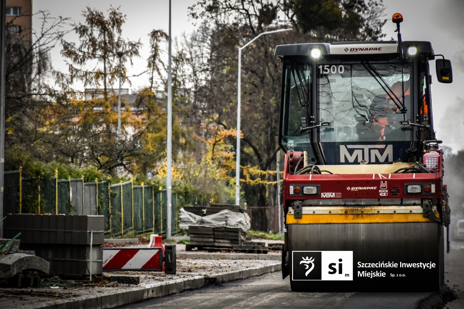 Na placu budowy panuje wzmożony ruch sprzętu drogowego.